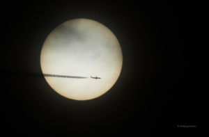Airplane in front of the sun